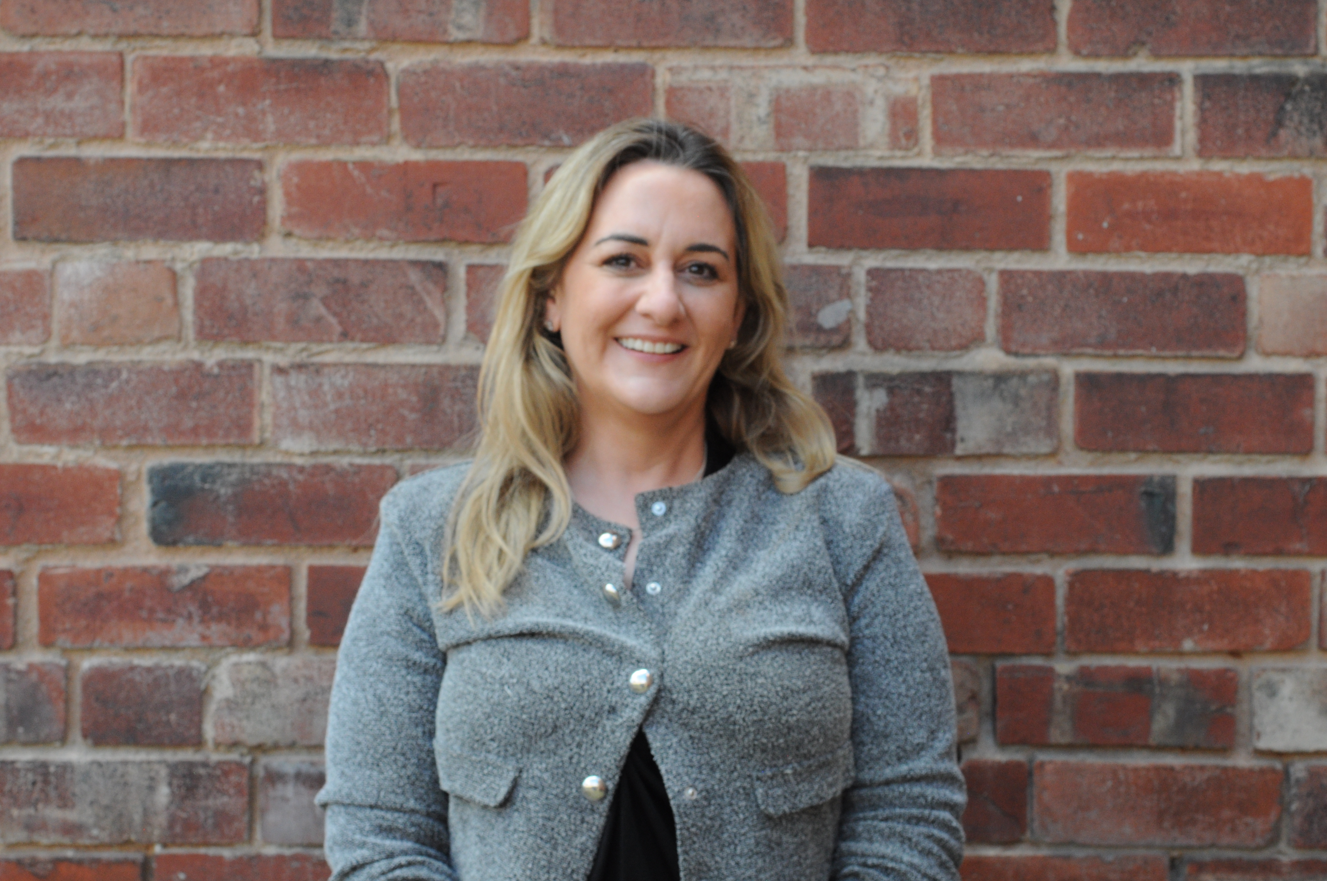Picture of Claire Wilks on brick background